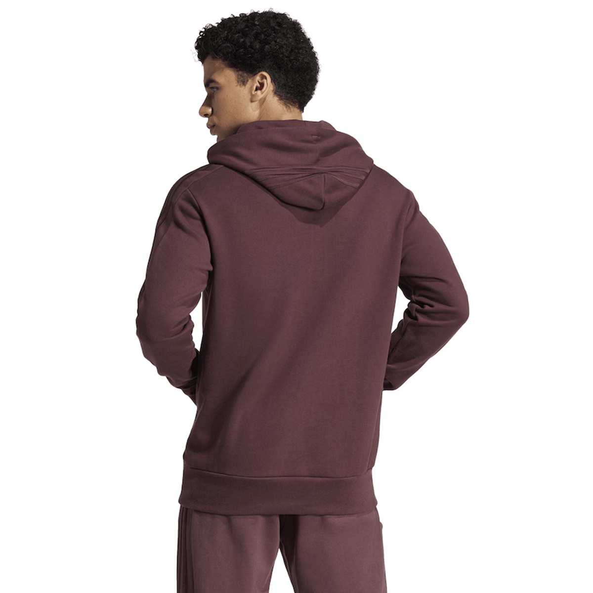 Facing away from the camera, the person is wearing the adidas All Blacks 24/25 Fan Rugby Hoodie paired with matching maroon pants, standing against a plain background.