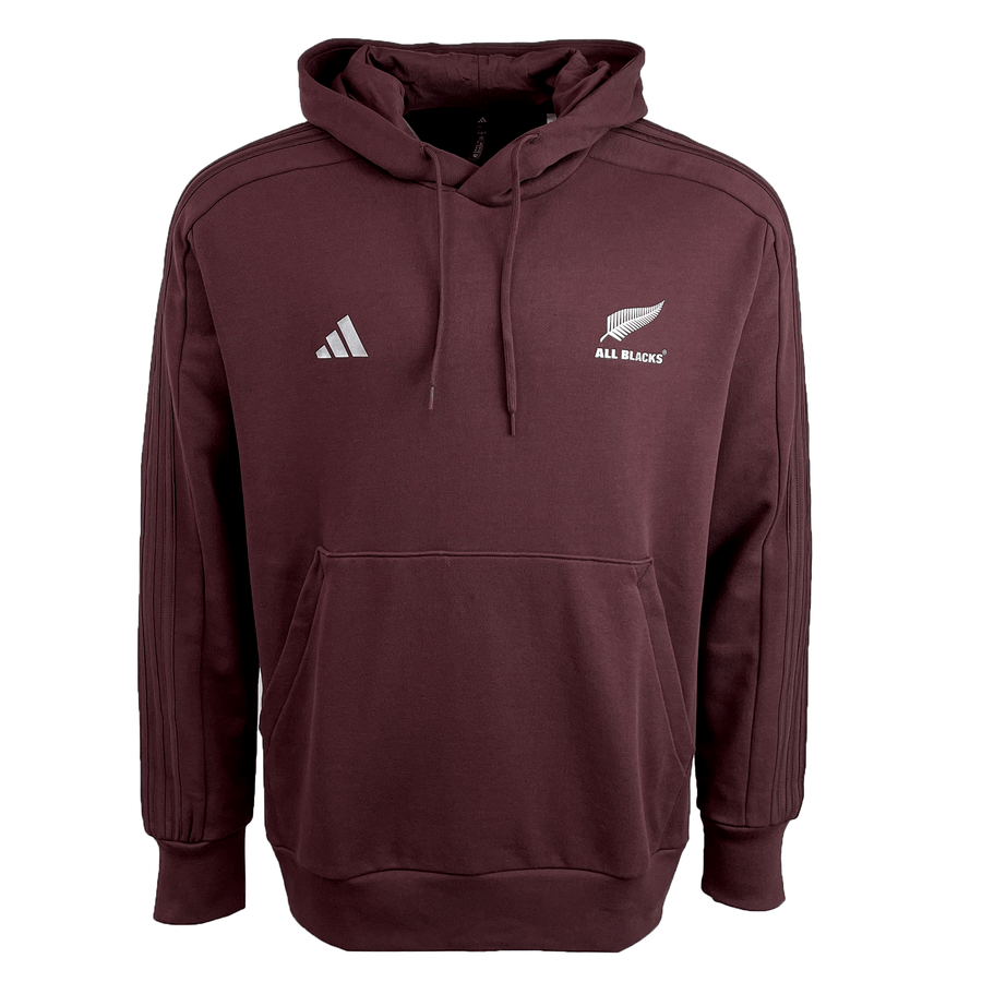 The All Blacks 24/25 Fan Rugby Hoodie by adidas features a maroon color with a hood, front pocket, the adidas logo on the left chest, and the iconic All Blacks logo with silver fern on the right chest—a must-have rugby hoodie for any New Zealand fan’s wardrobe.