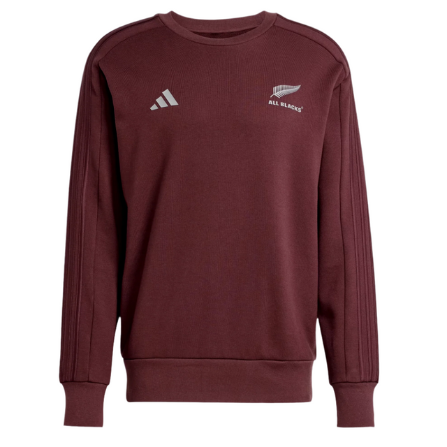 The All Blacks 24/25 Fan Crewneck Sweatshirt by adidas is maroon with a white fern leaf logo on the right chest and the adidas logo with signature 3-Stripes on the left, capturing the All Blacks' spirit.