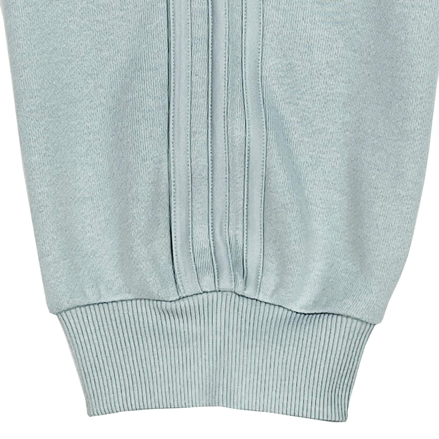 Close-up of a ribbed-textured light blue sleeve cuff with vertical stitching, echoing the precision found in adidas's Women's All Blacks 24/25 Fan Cuffed Pant.
