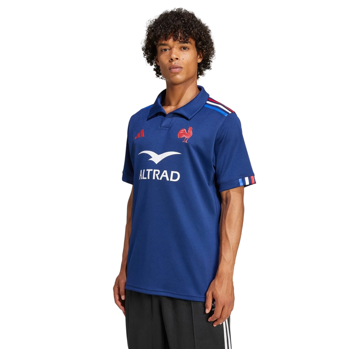 A person wearing the adidas France FFR 25/26 Replica Home Jersey in blue with red and white accents, standing against a plain white background.