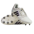 A pair of adidas Kakari Avaglide SG rugby boots in Off White/Grey Five, with one boot upright and the other displaying the metal-studded sole for soft ground play.