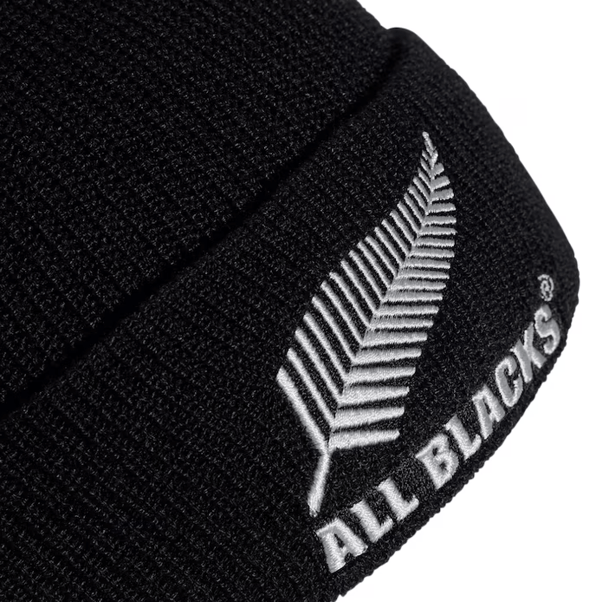 The All Blacks 24/25 Fisherman Beanie by adidas is a chic black hat that showcases a white fern logo and "ALL BLACKS" embroidery, making it an ideal tribute to rugby legends.