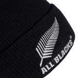 The All Blacks 24/25 Fisherman Beanie by adidas is a chic black hat that showcases a white fern logo and "ALL BLACKS" embroidery, making it an ideal tribute to rugby legends.