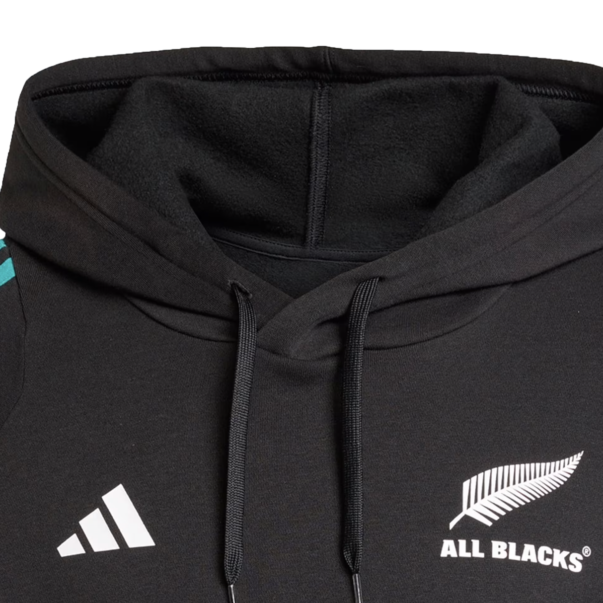 Close-up of the adidas All Blacks 25/26 Training Hoodie, showcasing the iconic silver fern and adidas logos—a must-have for any rugby fan.