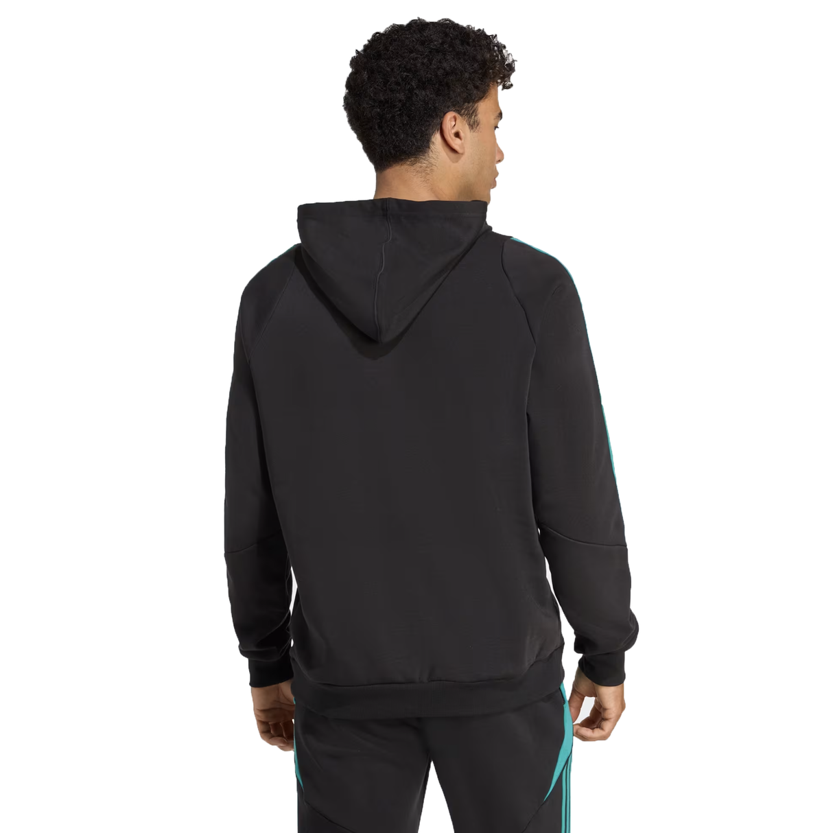 A man stands facing away, wearing the adidas All Blacks 25/26 Training Hoodie and matching black pants with teal stripes—ideal rugby fan apparel.