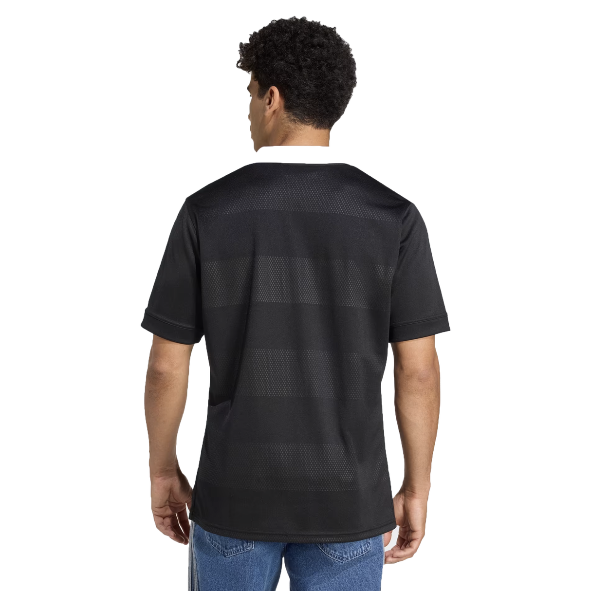 A person wearing the adidas All Blacks 25/26 Replica Home Jersey and blue jeans is shown from the back against a white background.