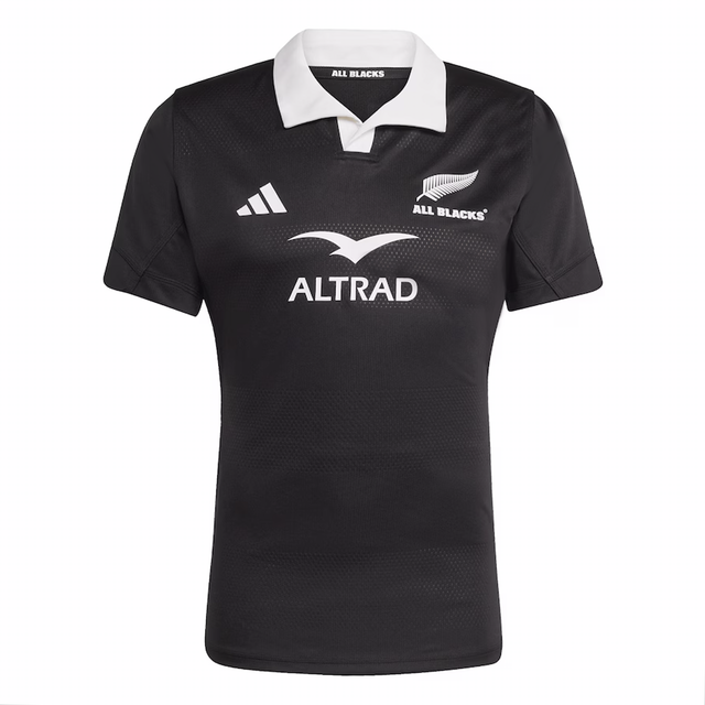 The All Blacks 25/26 Performance Home Jersey by adidas is a black rugby jersey with a white collar, featuring the All Blacks logo, adidas branding, and "ALTRAD" sponsor text on the front.