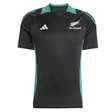 The All Blacks 25/26 Performance T-Shirt by adidas features black and teal colors, short sleeves, the silver fern emblem, and the adidas logo on the chest.