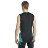 A man faces away from the camera, wearing the adidas All Blacks 25/26 Training Singlet and black and teal shorts, ready for rugby training.