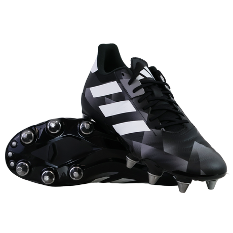 A pair of adidas Kakari Z.2 SG rugby boots in black, white, and carbon—one upright and one showing the metal studded sole—ideal soft ground boots for powerful forwards.