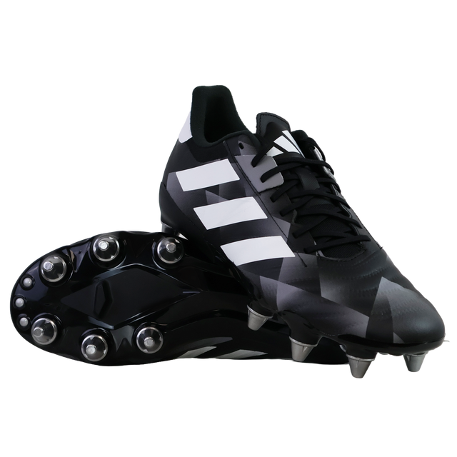 A pair of adidas Kakari Z.2 SG rugby boots in black, white, and carbon—one upright and one showing the metal studded sole—ideal soft ground boots for powerful forwards.