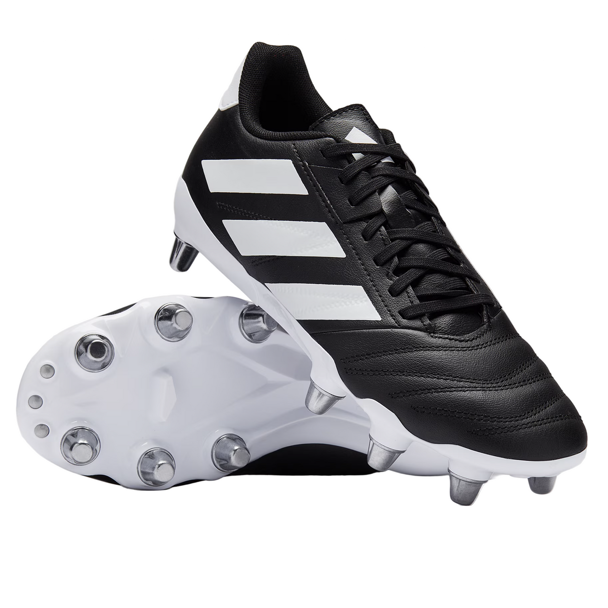 A pair of adidas Kakari Elite SG boots in Core Black/White/Core Black—one upright, one on its side revealing metal studs—ideal for soft ground play and showcasing the classic adidas rugby design.