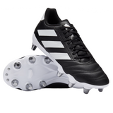A pair of adidas Kakari Elite SG boots in Core Black/White/Core Black—one upright, one on its side revealing metal studs—ideal for soft ground play and showcasing the classic adidas rugby design.