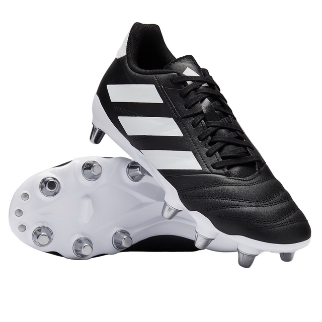 A pair of adidas Kakari Elite SG boots in Core Black/White/Core Black—one upright, one on its side revealing metal studs—ideal for soft ground play and showcasing the classic adidas rugby design.