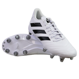 A pair of adidas Kakari SG rugby boots in White/Core Black/Silver Metallic, featuring black stripes and metal soft ground studs, are displayed—one upright and one showing the sole—against a plain white background.