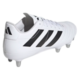 The adidas Kakari SG in White/Core Black/Silver Metallic features black stripes and metal studs for soft ground, shown here from the back and side.