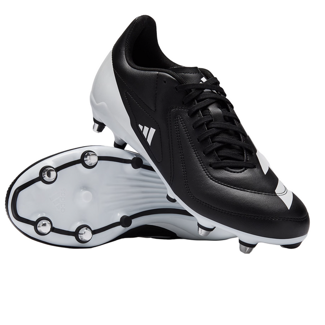 The adidas RS15 SG rugby boots in Black/White/Silver are displayed, with one shoe upright and the other showcasing the sole and studs.