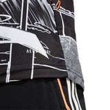 Close-up of the All Blacks 26/27 Captains Run Replica Jersey by adidas, showcasing a black and white graphic design with "AEROREADY" on the lower hem, paired with black shorts featuring bold orange and white stripes.
