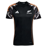 The All Blacks 26/27 Marvel Performance Training Tee by adidas features white logos, orange side accents, and patterned black, white, and orange sleeves—ideal as a rugby performance shirt.