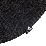 Close-up of a dark gray knit with a black adidas tag featuring the white logo and text—a must-have for fans of the All Blacks 25/26 Beanie by adidas.