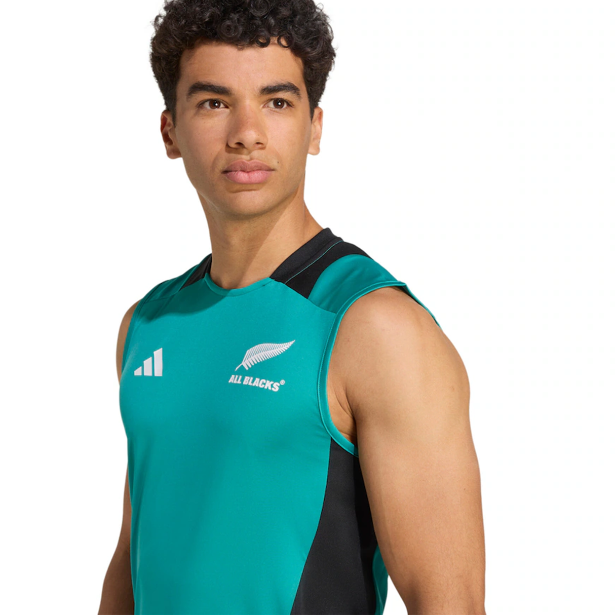 A man stands in a sleeveless teal and black All Blacks 25/26 Training Singlet by adidas, facing slightly to the side against a plain background, ready for rugby training.