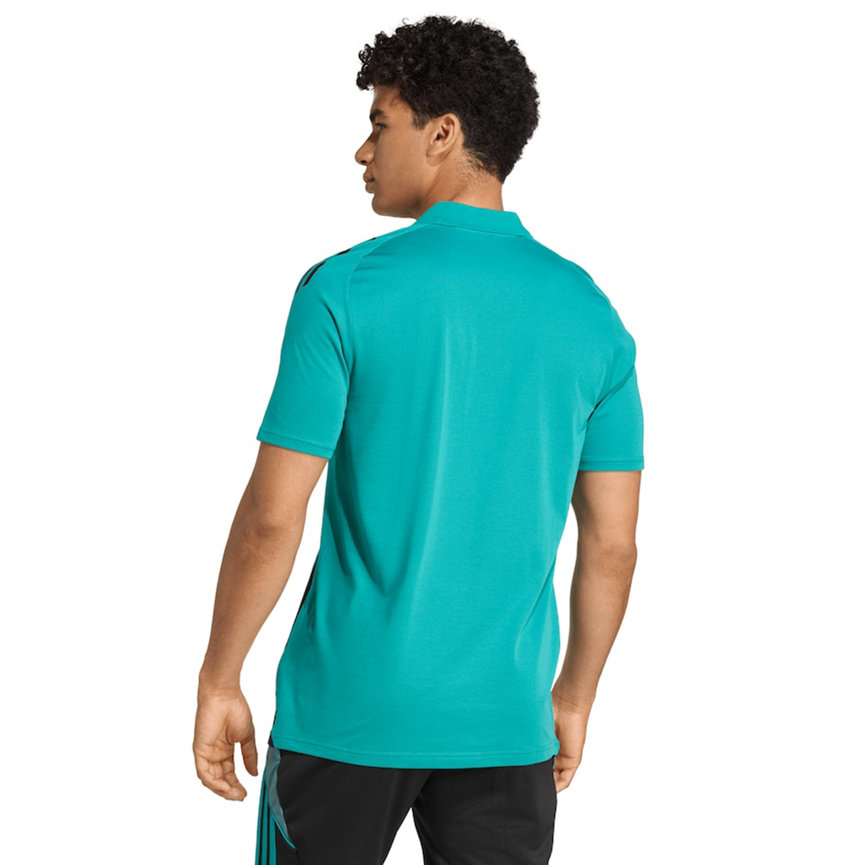 A man faces away, wearing the adidas All Blacks 25/26 Training Polo in teal with black pants, set against a white background.