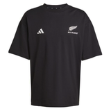 The All Blacks 25/26 Presentation T-Shirt by adidas features the iconic logo and silver fern on black—an essential piece for rugby fans.