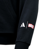 A close-up of the All Blacks 26/27 Marvel Hoodie by adidas shows its black sleeve with white adidas and red Marvel logos printed side by side.