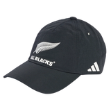 The All Blacks 25/26 Tech Baseball Cap by adidas features a bold silver fern and "ALL BLACKS" text on the front, plus adidas' signature three white diagonal stripes on the side.