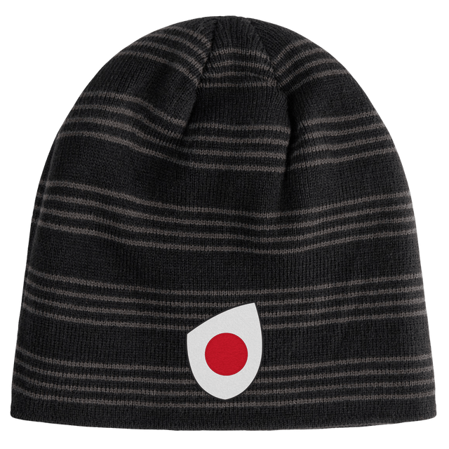 The EMB Canterbury Japan Shield Beanie sports a bold black and gray striped pattern, accented by a prominent red and white circular logo on the front.