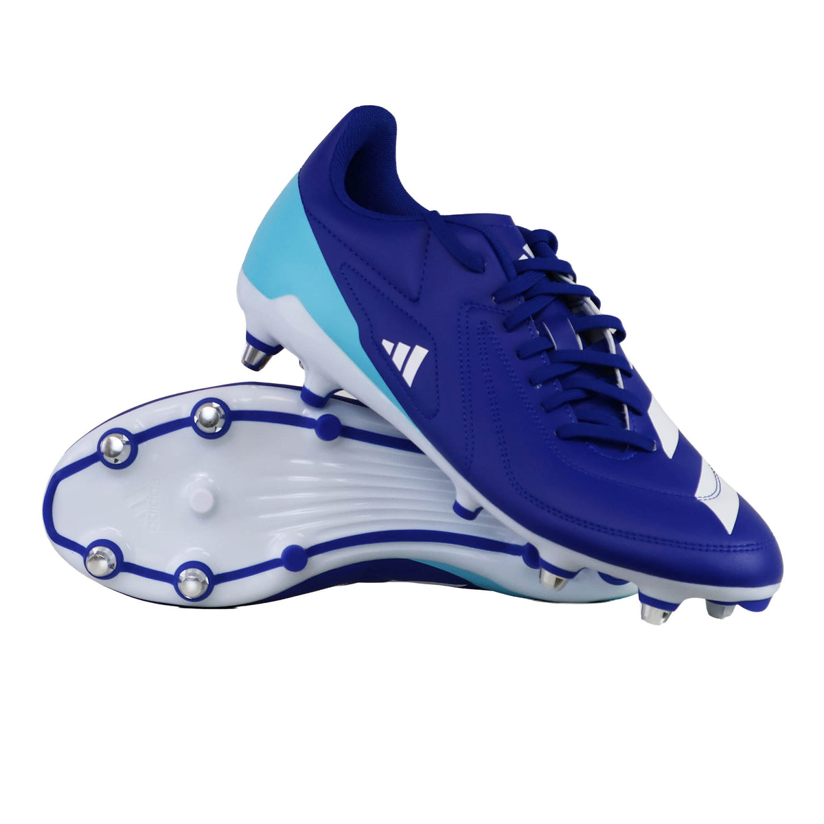 A pair of adidas RS-15 SG rugby boots in Royal, White, and Light Blue—one standing upright and the other on its side to display the soft ground metal studs designed for maximum traction.
