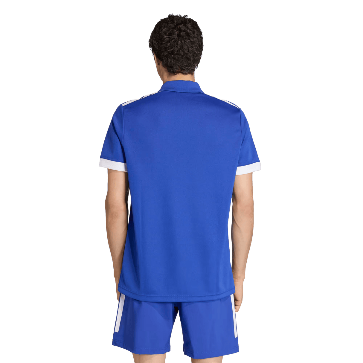 With their back to the camera, a person with short curly hair wears an adidas France FFR Home Supporters Replica Polo and matching blue shorts with white accents—a classic look for any France FFR fan.