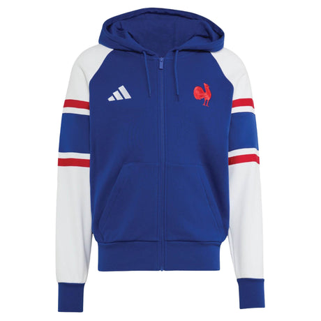 Discover the France FFR 26/27 Travel Full Zip Hoodie by adidas—a blue full-zip hoodie featuring white sleeves, red and blue stripe accents, two front pockets, and embroidered chest logos. This adidas piece is perfect for France Rugby fans who want sporty style and comfort.