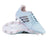 A pair of adidas RS-15 Avaglide Rise SG women’s rugby boots in Ice Blue, Iron, and Pink, featuring black stripes and white soles with metal and pink studs. One shoe is upright and the other displays the sole, making them ideal soft ground rugby boots.