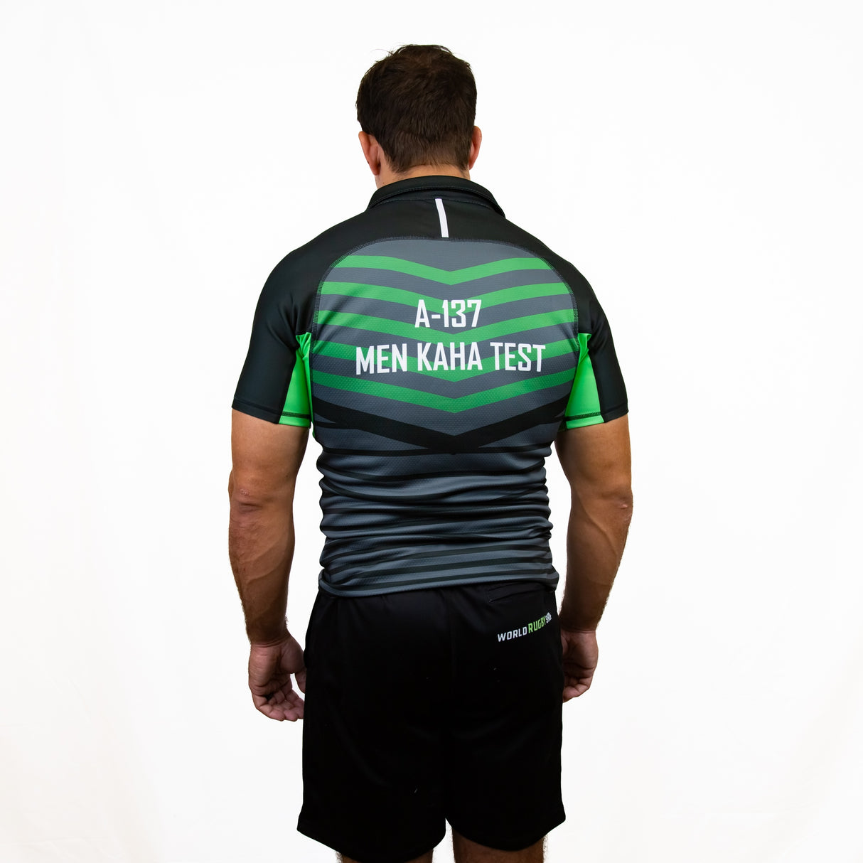 A man stands facing away, wearing the Teamatical Canterbury Elite Full Custom Sublimated Jersey - Mens, with "A-137 MEN KAHA TEST" printed on the back.