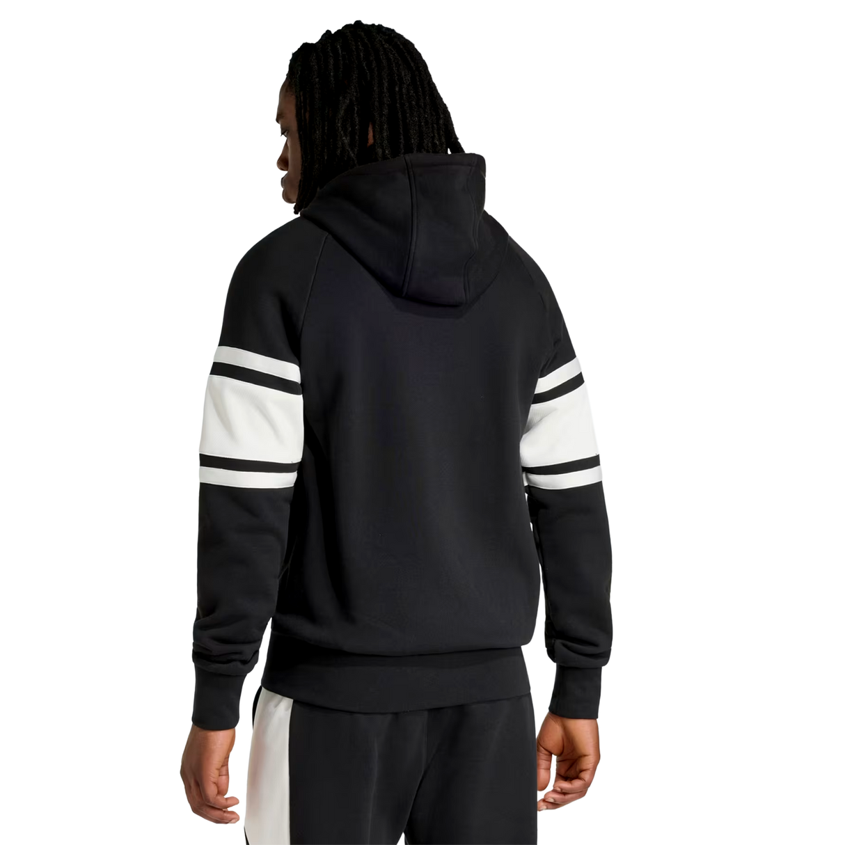 A person is seen from the back against a plain background, wearing the adidas All Blacks 26/27 Travel Full Zip Hoodie with white and black striped sleeves and black pants with a white stripe.