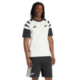 A person wearing the All Blacks 26/27 Travel T-Shirt by adidas with matching black shorts, standing against a plain white background.