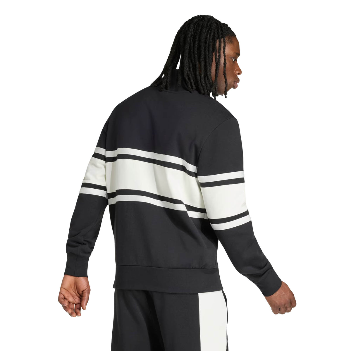A man with long braided hair, facing away from the camera against a plain background, wears the All Blacks 26/27 Leisurewear 1/4 Zip Sweatshirt by adidas—a perfect showcase of New Zealand Rugby leisurewear styled with its black fabric and white and black horizontal stripes.