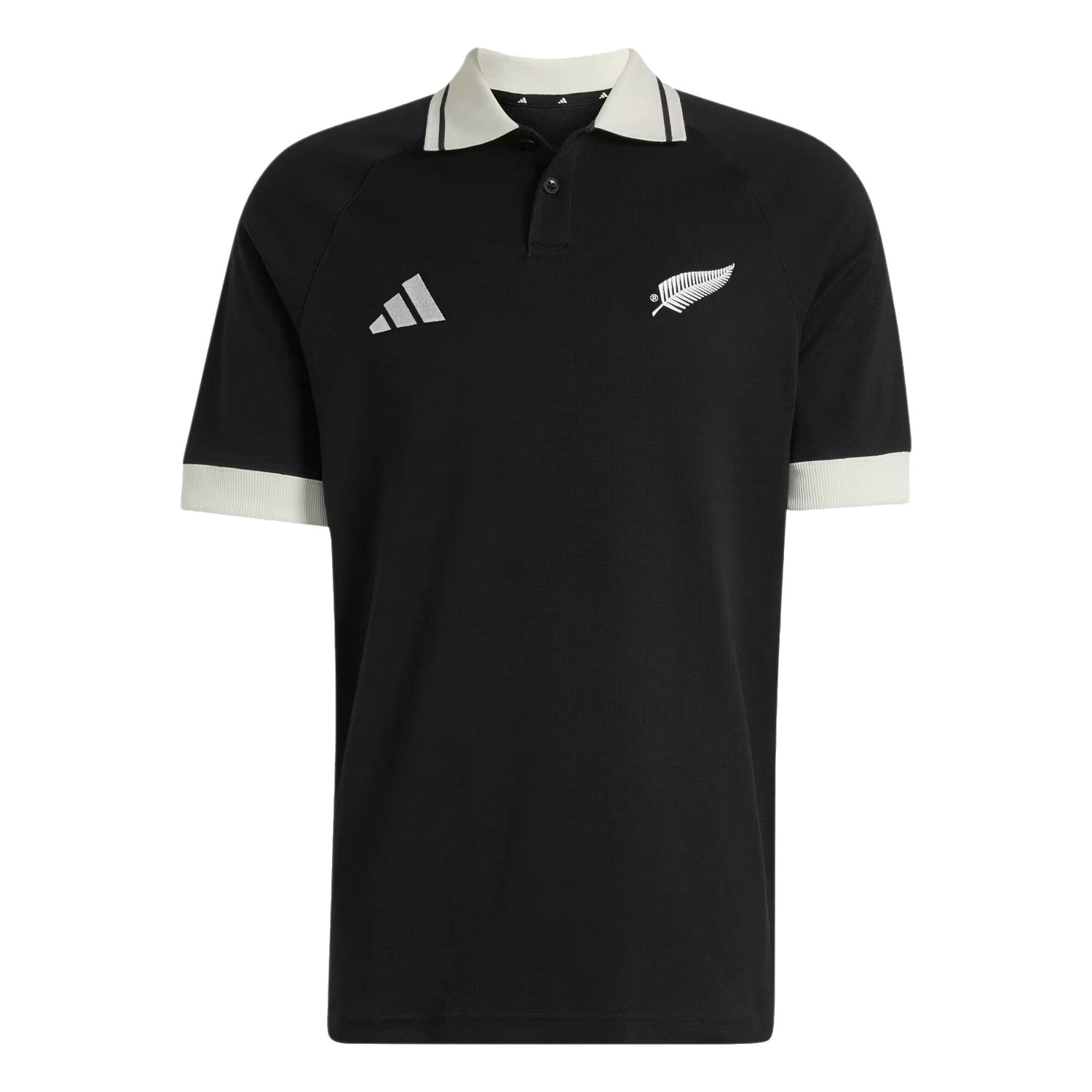 Wearing the All Blacks 26/27 Travel Polo by adidas, you’ll sport a black short-sleeve polo shirt with a crisp white collar and sleeve cuffs. Featuring the adidas logo on the right chest and the silver fern emblem on the left, this stylish top captures the spirit of the iconic New Zealand Rugby shirt.
