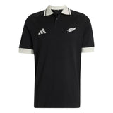 Wearing the All Blacks 26/27 Travel Polo by adidas, you’ll sport a black short-sleeve polo shirt with a crisp white collar and sleeve cuffs. Featuring the adidas logo on the right chest and the silver fern emblem on the left, this stylish top captures the spirit of the iconic New Zealand Rugby shirt.
