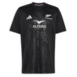 The All Blacks Greatest Rivalry Supporters Tee by adidas showcases the adidas, Altrad, and All Blacks logos on the front, features a subtle leaf pattern in black, and is an essential piece for every New Zealand rugby fan.