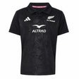 Youth-sized black rugby polo jersey from adidas with All Blacks and Altrad logos on the front, showcasing a subtle fern pattern and classic collar—an authentic Youth All Blacks Greatest Rivalry Replica Home Jersey inspired by New Zealand Rugby.