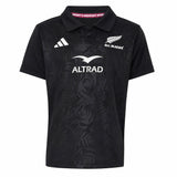 Youth-sized black rugby polo jersey from adidas with All Blacks and Altrad logos on the front, showcasing a subtle fern pattern and classic collar—an authentic Youth All Blacks Greatest Rivalry Replica Home Jersey inspired by New Zealand Rugby.