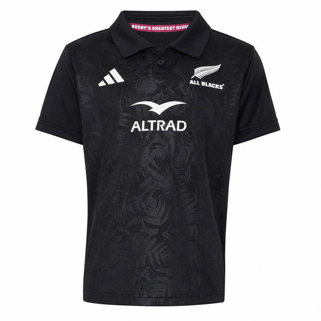 Youth-sized black rugby polo jersey from adidas with All Blacks and Altrad logos on the front, showcasing a subtle fern pattern and classic collar—an authentic Youth All Blacks Greatest Rivalry Replica Home Jersey inspired by New Zealand Rugby.