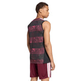A person wearing an adidas All Blacks Greatest Rivalry Training Singlet, which is sleeveless and features a black and maroon pattern, along with maroon athletic shorts, is standing and facing away from the camera against a white background.