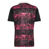 All Blacks 26/27 Training Jersey - South Africa Tour by adidas: A short-sleeve adidas jersey featuring a white collar, black sleeves, and a pink and black leaf pattern on the back—reminiscent of styles worn by the All Blacks for training during their South Africa tour.
