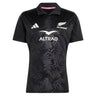 Elevate your rugby collection with the All Blacks Greatest Rivalry Performance Home Jersey by adidas—a black short-sleeve jersey featuring a distinctive fern pattern, classic collar with “RUGBY’S GREATEST” printed inside, and bold white sponsor and team logos, designed for true fans of performance rugby shirts.