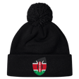 Just In: The stylish Kenya Shield Pom Pom Beanie by EMB Canterbury, featuring a black design with the iconic Kenya Shield emblem on the front and a fashionable pom-pom.