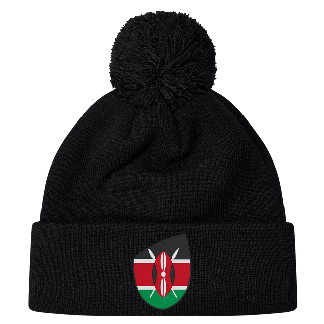 Just In: The stylish Kenya Shield Pom Pom Beanie by EMB Canterbury, featuring a black design with the iconic Kenya Shield emblem on the front and a fashionable pom-pom.